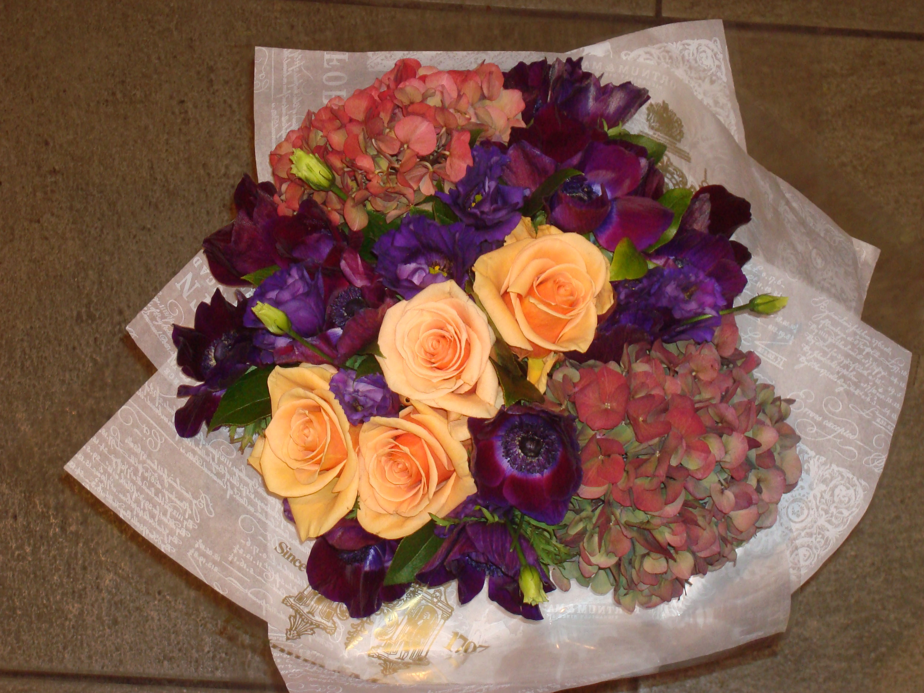 Violetta dark purple anenomies hydrangeas and orange roses